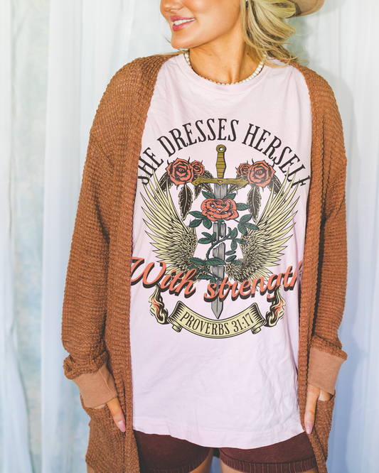 she dresses herself with strength